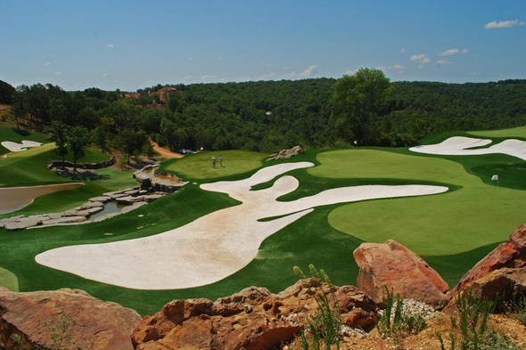 Toronto lush green synthetic grass golf course with white sand bunkers and blue sky